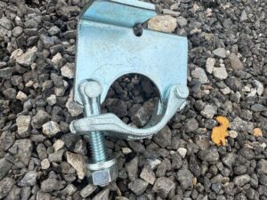 Scaffold board retaining clamp
