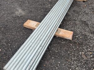 Bundle of new galvanised steel scaffold tubes, 48.3mm diameter × 13ft (3.9m) length, stacked outdoors