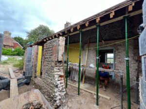 Size 2 acrow props supporting floor joists during building work