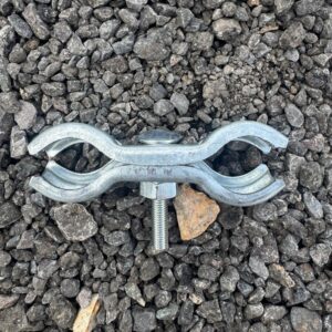 heras panel clip top down Top-down view of Heras fence coupler clamp on gravel surface