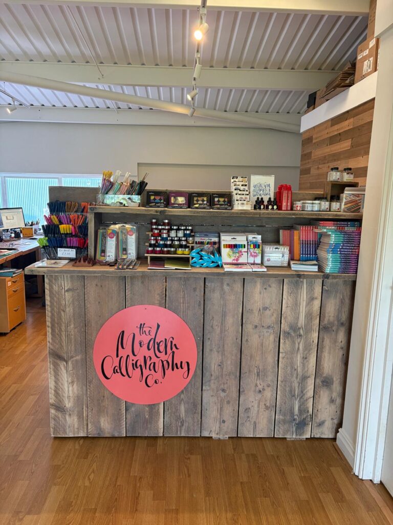 Reclaimed timber cladding on desk area at The Modern Calligraphy Co workspace in East Wittering, made using used wooden boards