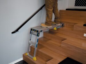 Adjustable PRO Work Platform safely used on stairs with independent leg adjustment for uneven surfaces
