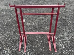 Size 1 adjustable builders trestle, red steel scaffold bandstand, shown fully extended on gravel ground