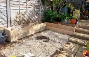 L-shaped garden planter made from reclaimed scaffold boards in Surrey